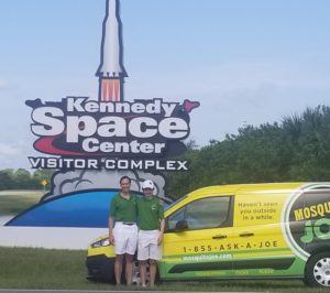 The Mosquito Joe of Melbourne owners stand in front of the Kennedy Space center with their Mosquito Joe of Melbourne van